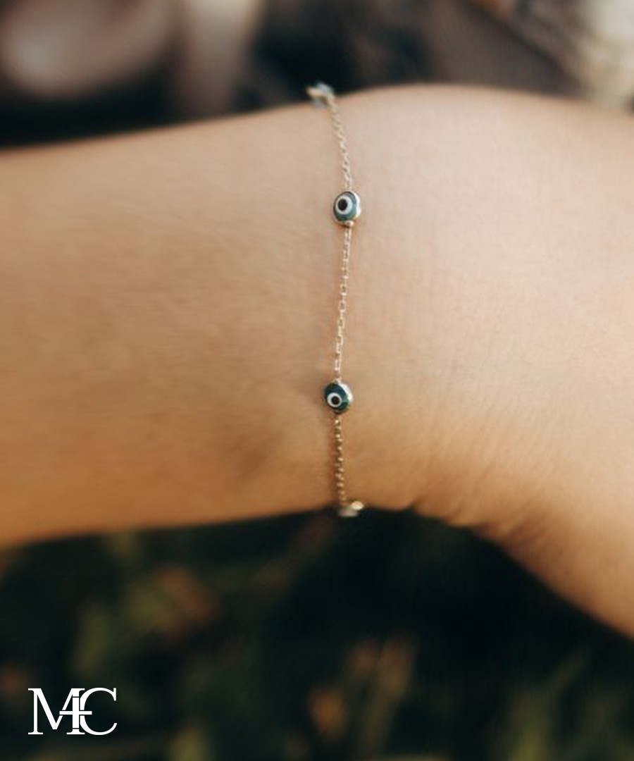 A delicate gold chain permanent bracelet on a wrist